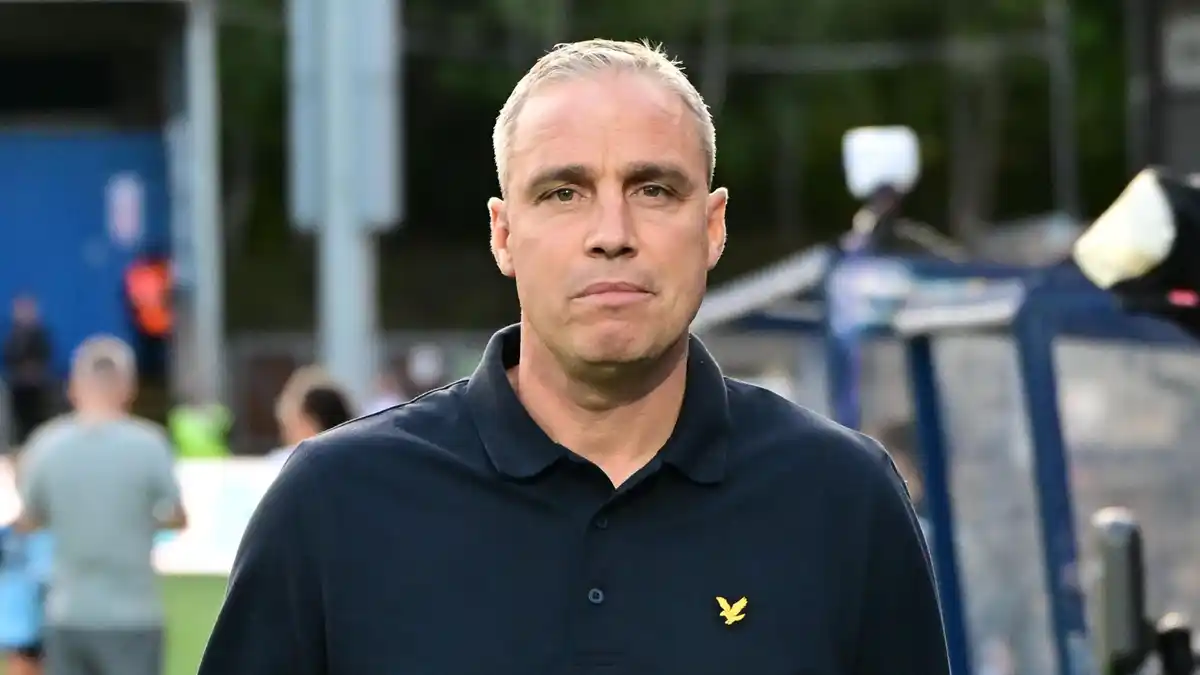 Michael Duff, wearing a dark buttoned top, during his time as Wycombe Wanderers manager
