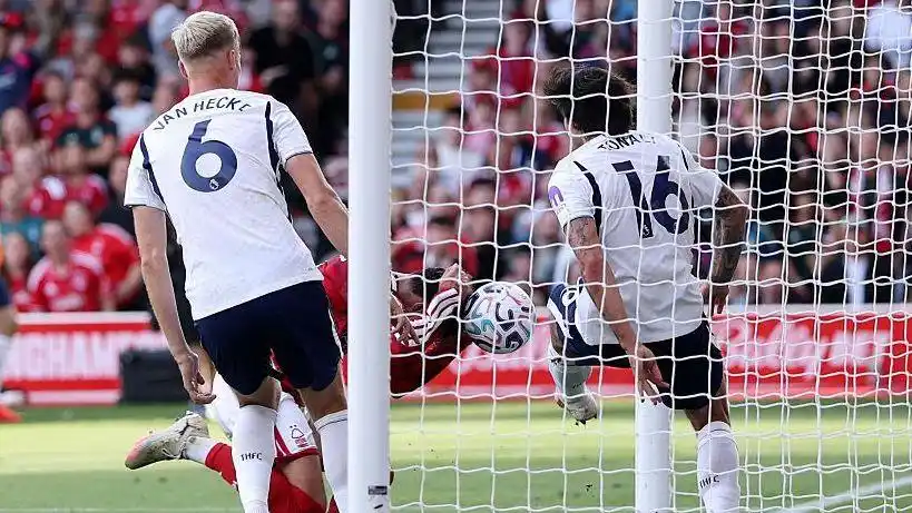 Nottingham Forest defender Neco Williams bundles the ball into the Tottenham net