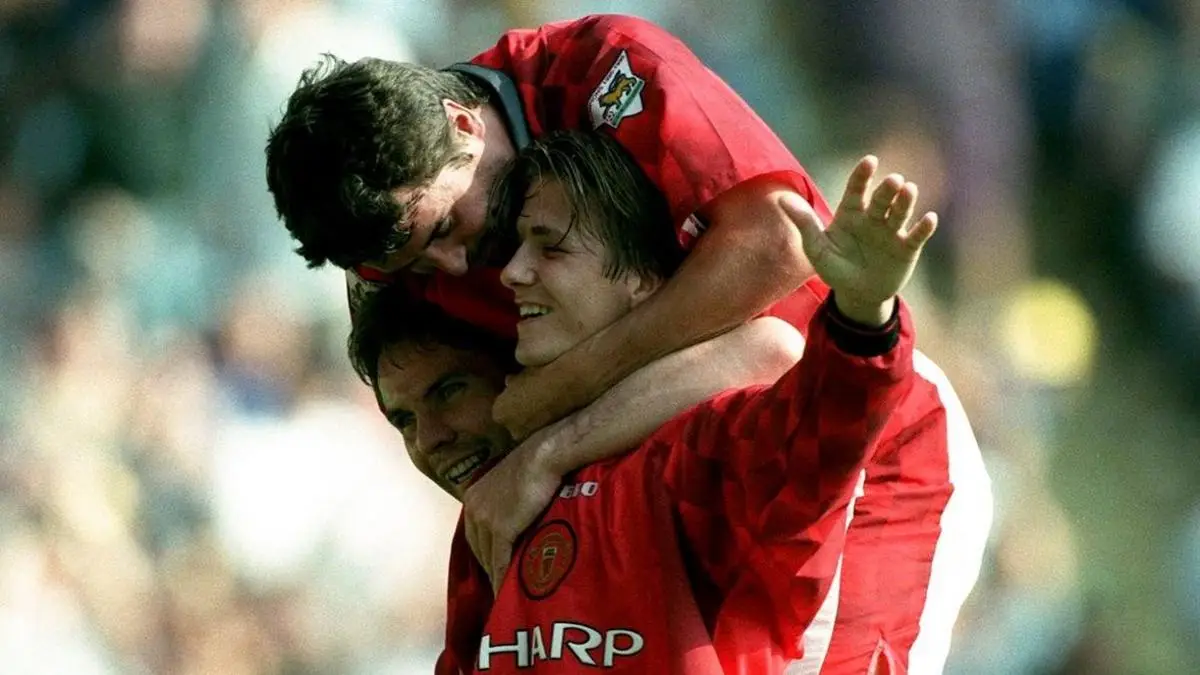 David Beckham is mobbed by team-mates including Roy Keane after his last-minute winner against AFC Wimbledon in 1996