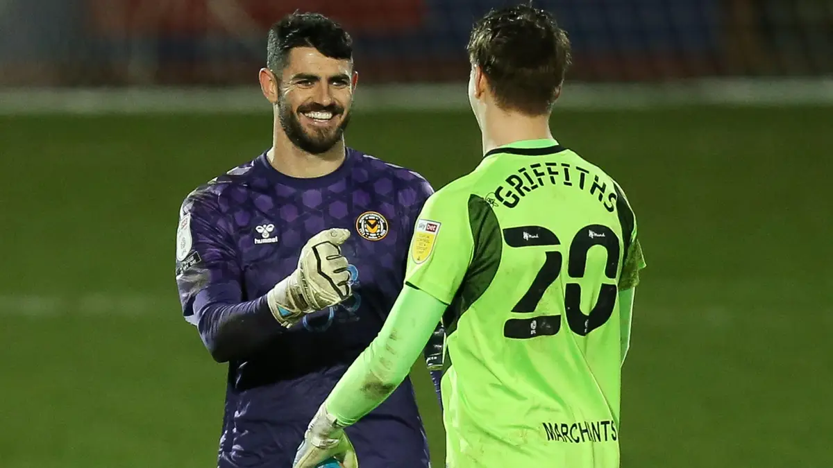 Tom King with Cheltenham keeper Josh Griffiths having scored the spectacular.